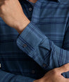 Model is wearing UNTUCKit Donnelly Shirt in blue grounded windowpane.