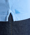 Model is wearing UNTUKit Vintage Wash Polo in Garment Dyed Blue. 