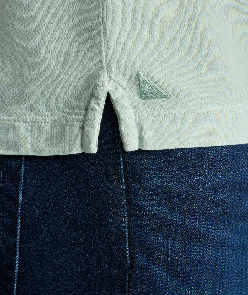 Model is wearing UNTUKit Vintage Wash Polo in Garment Dyed green. 
