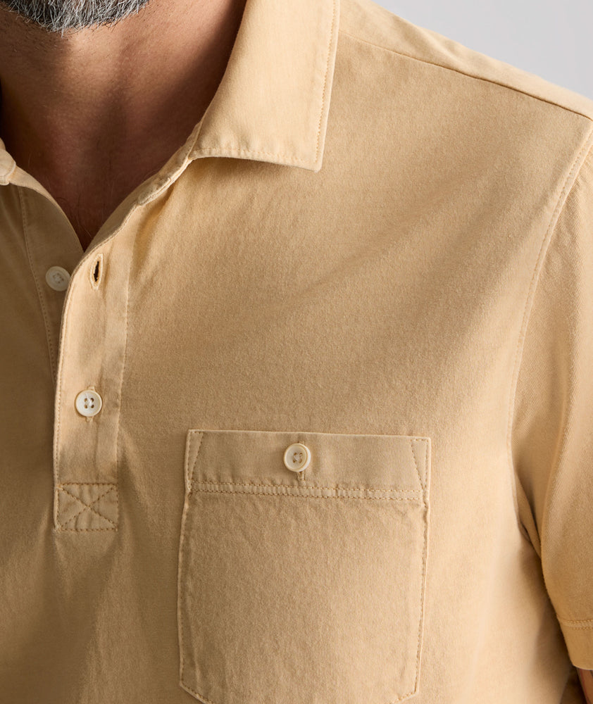 Model is wearing UNTUKit Vintage Wash Polo in Garment Dyed orange. 