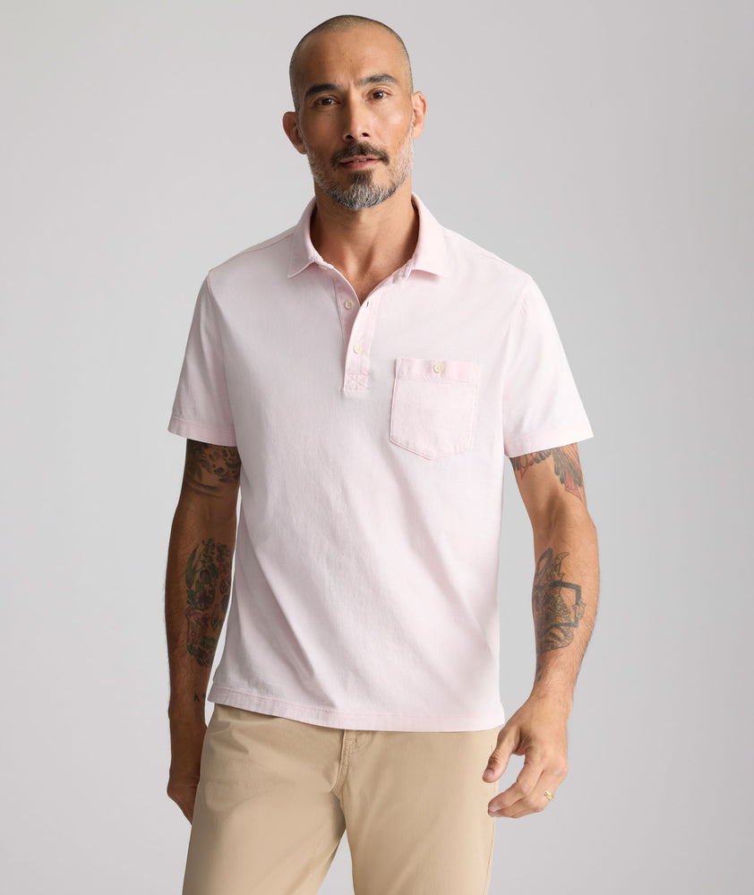 Model is wearing UNTUKit Vintage Wash Polo in Garment Dyed pink. 