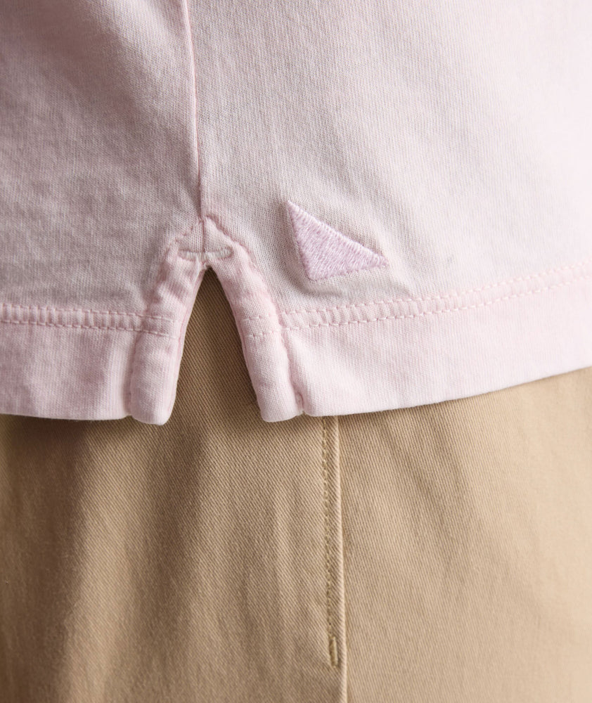 Model is wearing UNTUKit Vintage Wash Polo in Garment Dyed pink. 