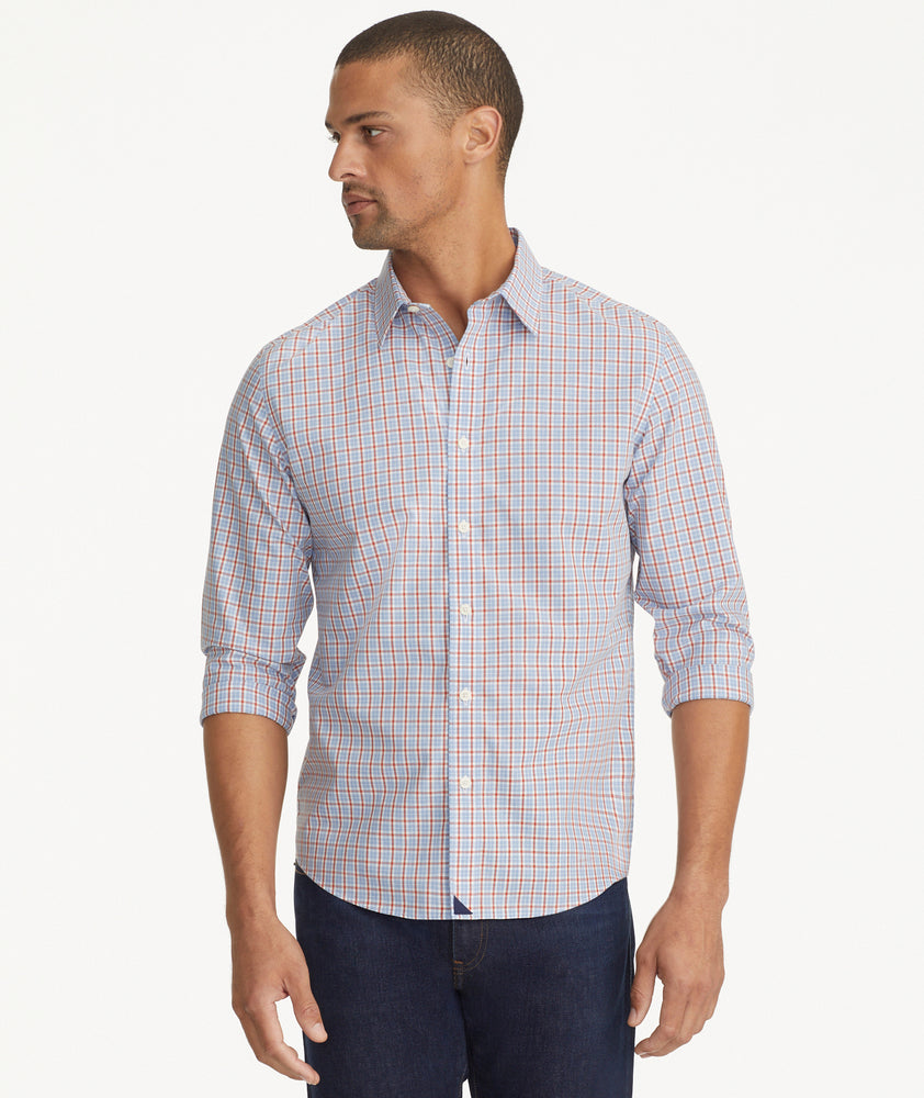Model is wearing UNTUCKit Wrinkle-Free Dutton Shirt in Blue& Red Check.