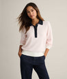 Model is wearing UNTUCKit Cotton-Cashmere Edyta Sweater Polo in pink. 