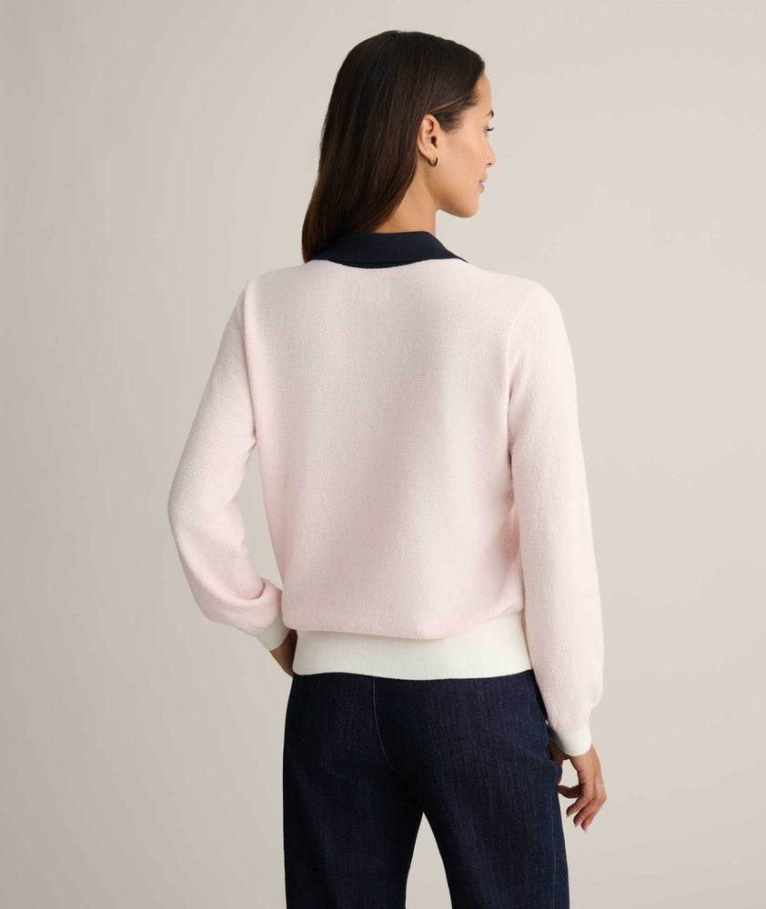 Model is wearing UNTUCKit Cotton-Cashmere Edyta Sweater Polo in pink. 