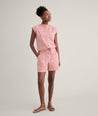 Model is wearing UNTUCKit Cotton Poplin Drawstring Elsa Shirt in Red Mini Floral print. 