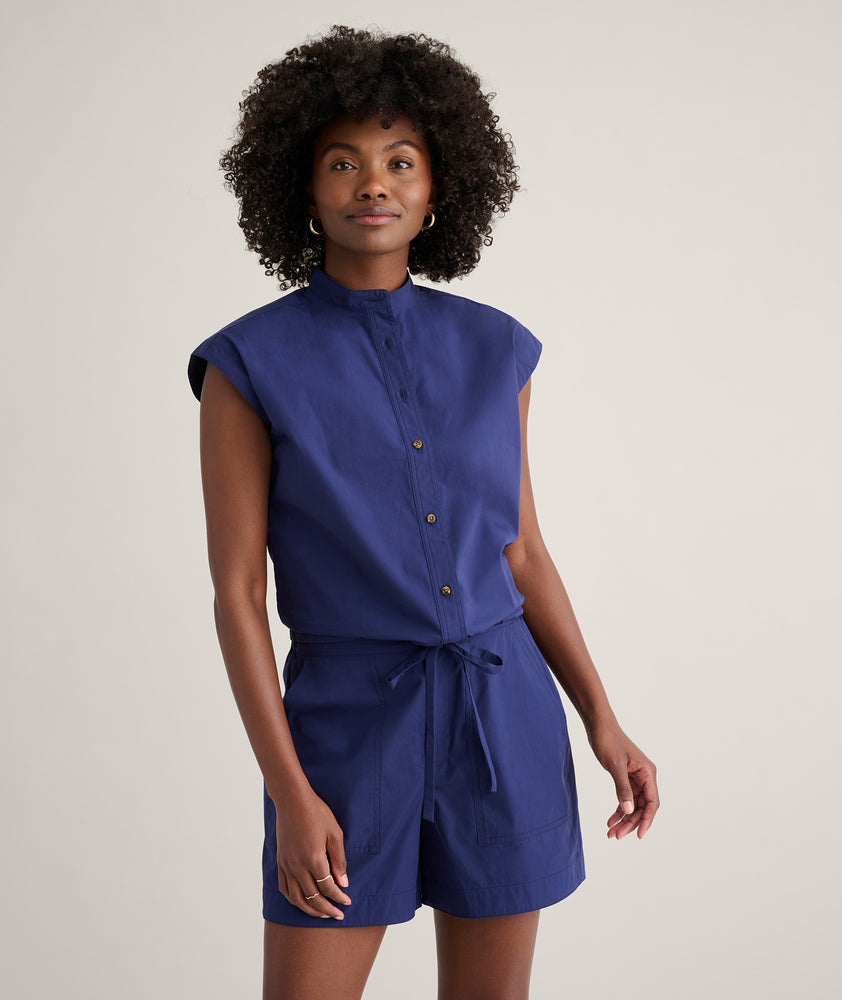 Model is wearing UNTUCKit Cotton Poplin Drawstring Elsa Shirt in solid navy. 