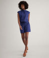 Model is wearing UNTUCKit Cotton Poplin Drawstring Elsa Shirt in solid navy. 