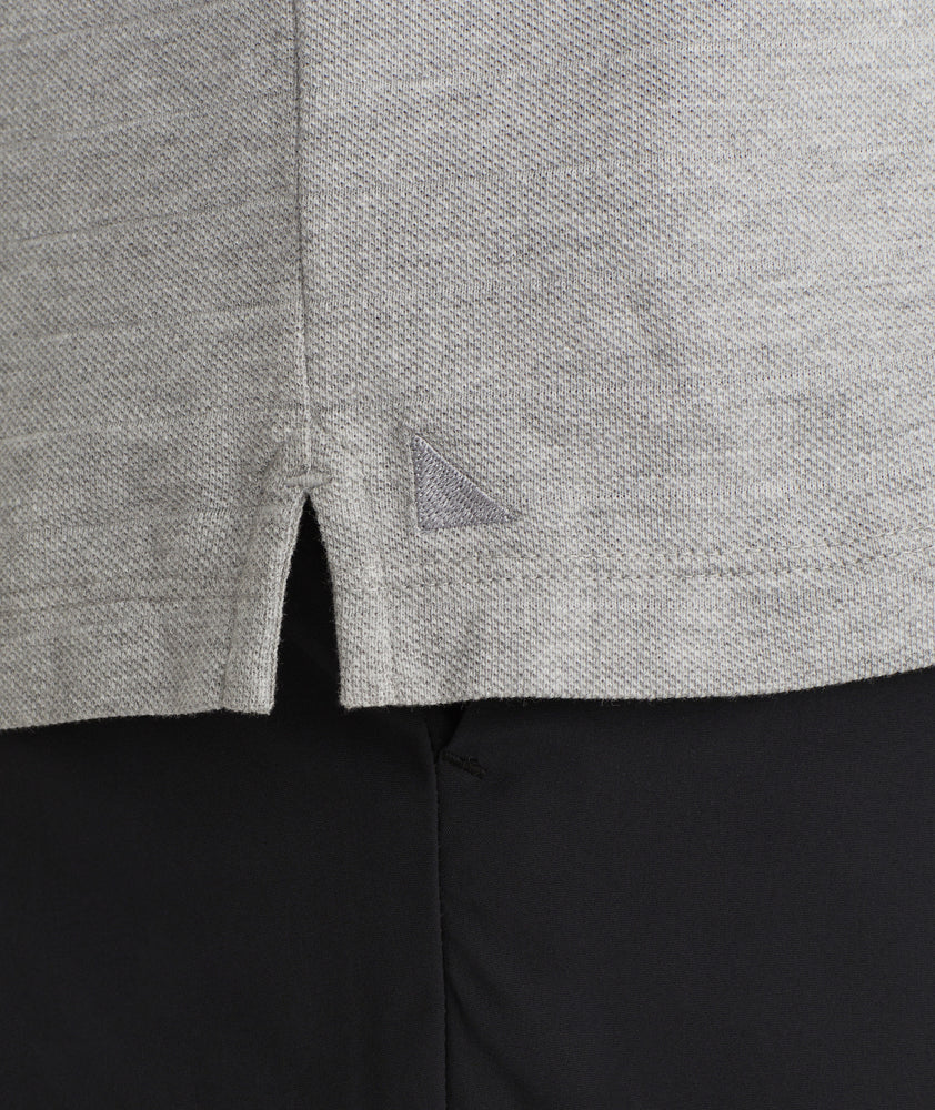 Model is wearing UNTUCKit Elvria Long sleeve polo in heather grey. 