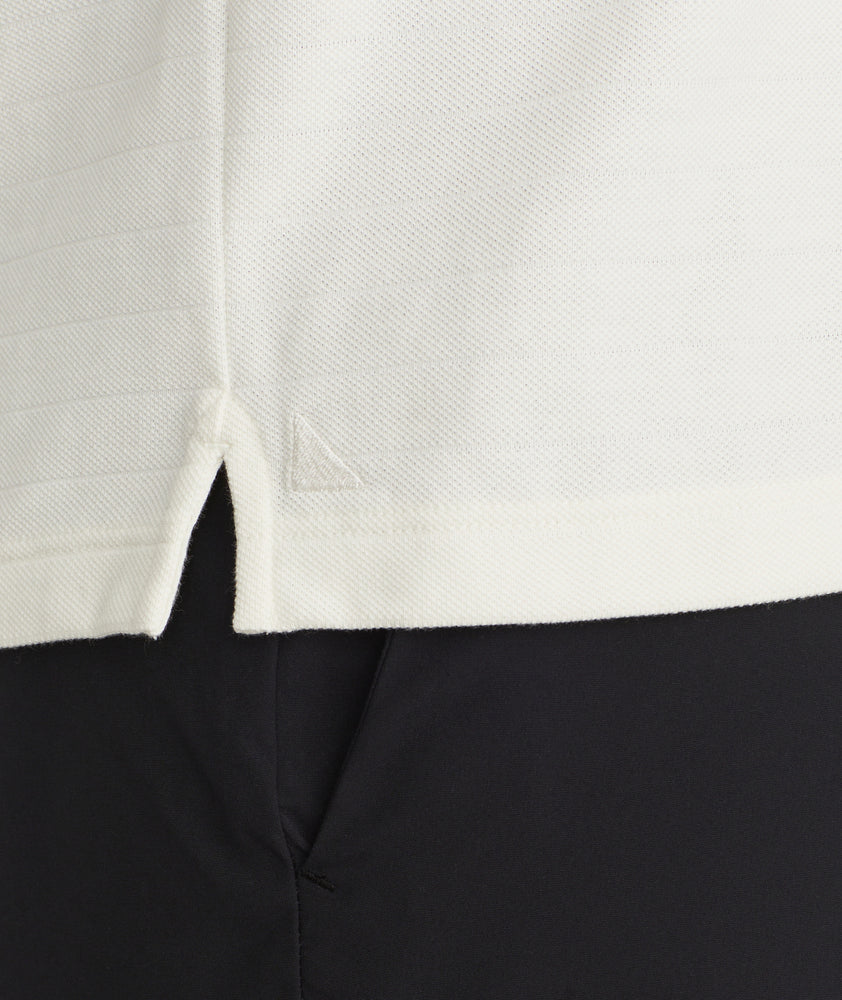 Model is wearing UNTUCKit Elvira long sleeve polo in vanilla ice.