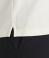 Model is wearing UNTUCKit Elvira long sleeve polo in vanilla ice.