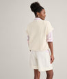 Model is wearing UNTUCKit Cotton Cap Sleeve Emily Sweater. 