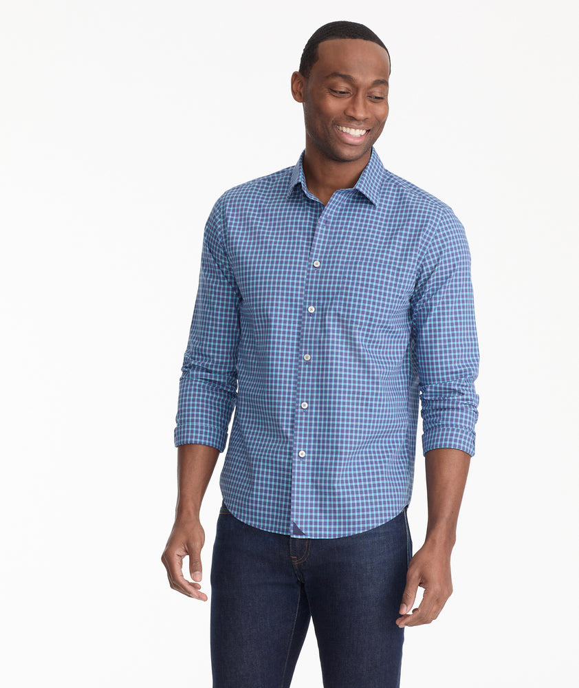 Model is wearing UNTUCKit Wrinkle-Free Emmett Shirt in Navy & Teal Check.