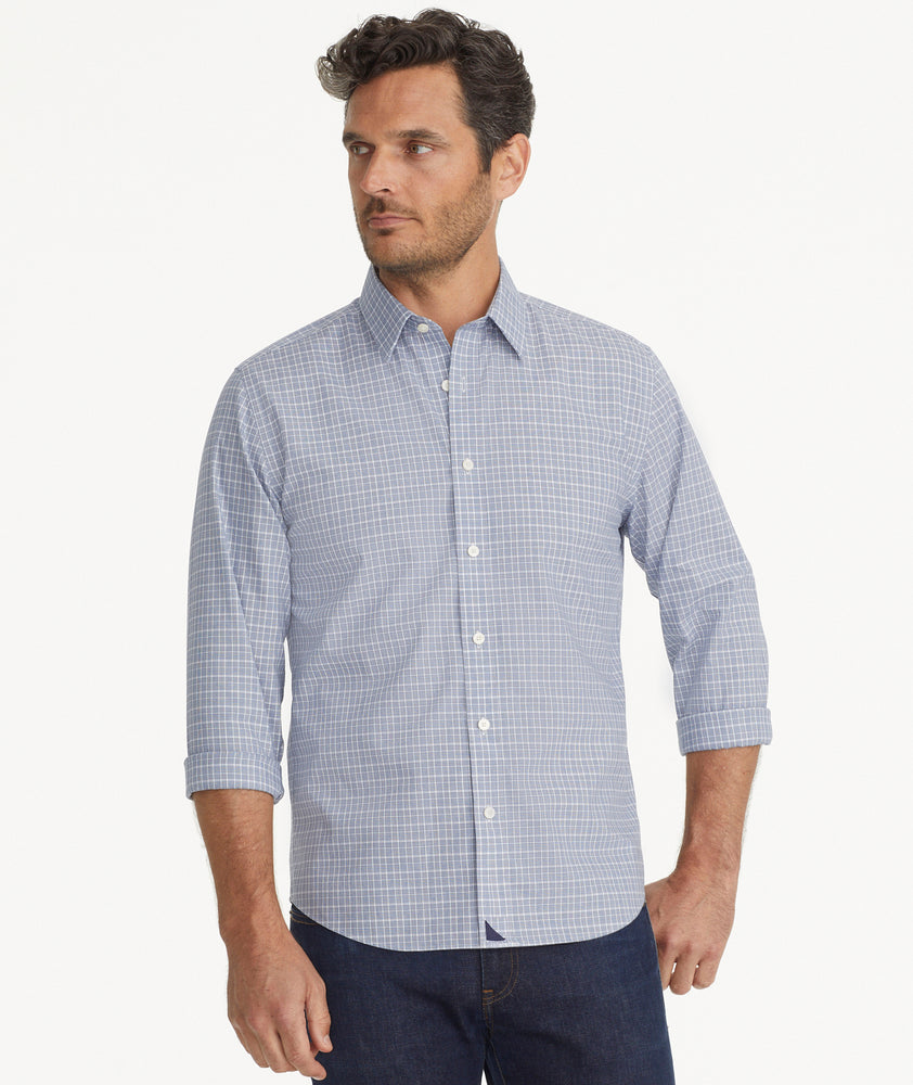 Model is wearing UNTUCKit Wrinkle-Free Erryk Shirt in Small Navy Check.