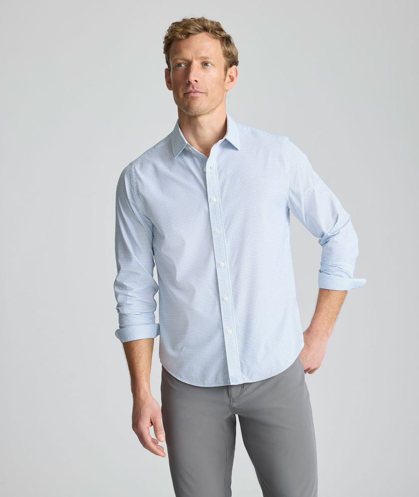 Model is wearing UNTUCKit Performance Fairfax Shirt in blue. 