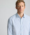 Model is wearing UNTUCKit Performance Fairfax Shirt in blue. 