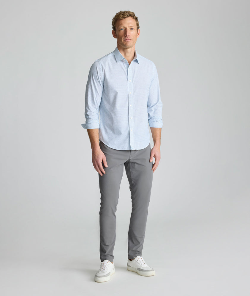Model is wearing UNTUCKit Performance Fairfax Shirt in blue. 