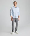 Model is wearing UNTUCKit Performance Fairfax Shirt in blue. 