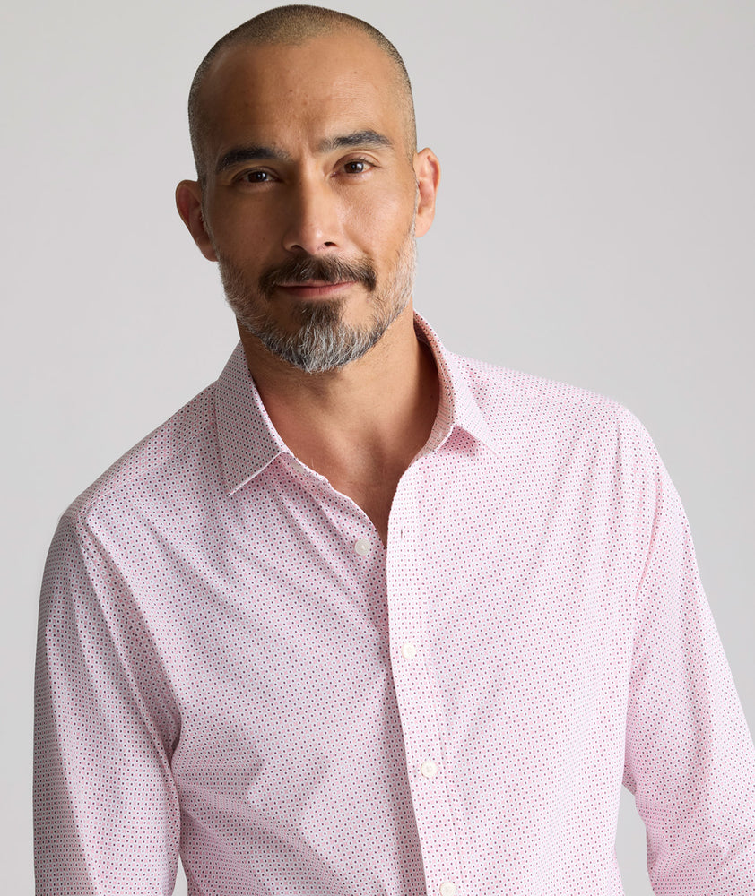 Model is wearing UNTUCKit Performance Fairfax Shirt in pink. 