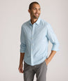 Model is wearing UNTUCKit Falkirk performance shirt in blue print. 