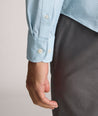Model is wearing UNTUCKit Falkirk performance shirt in blue print. 