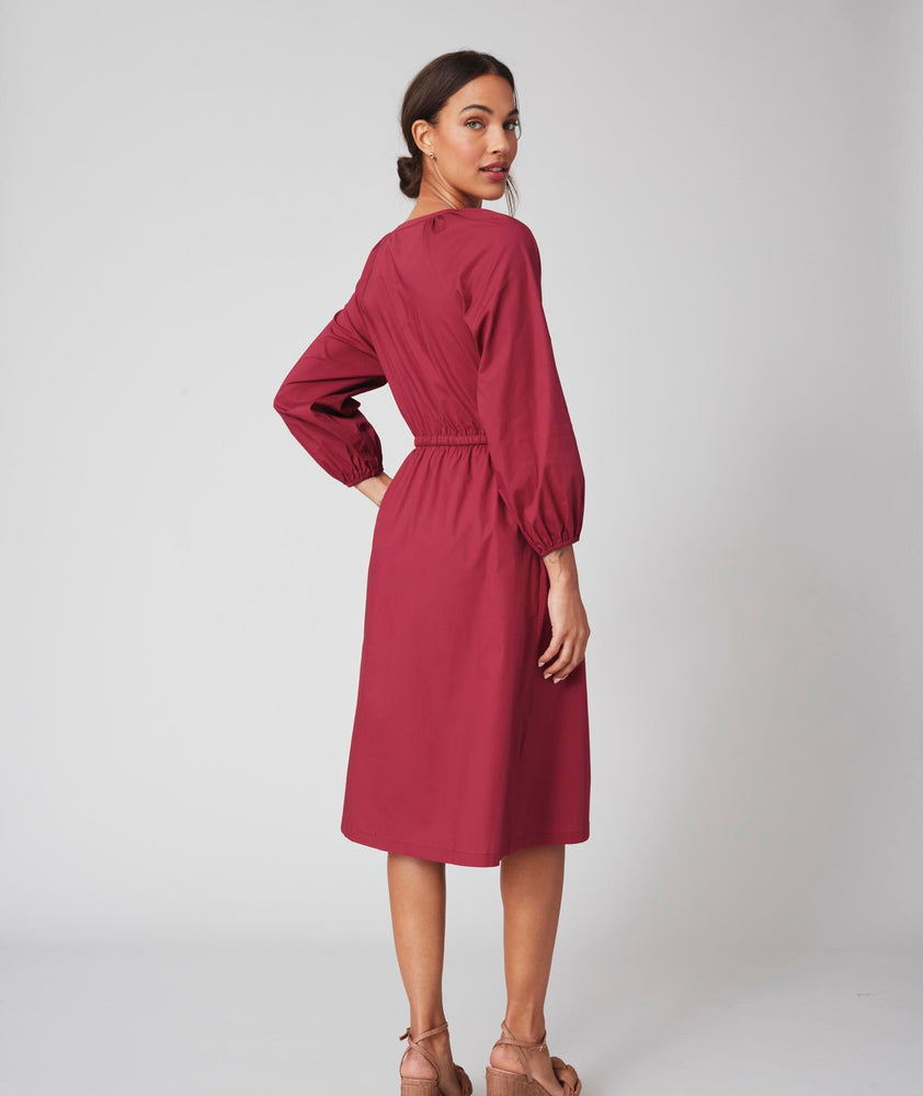 Model is wearing UNTUCKit Farrah dress in red.