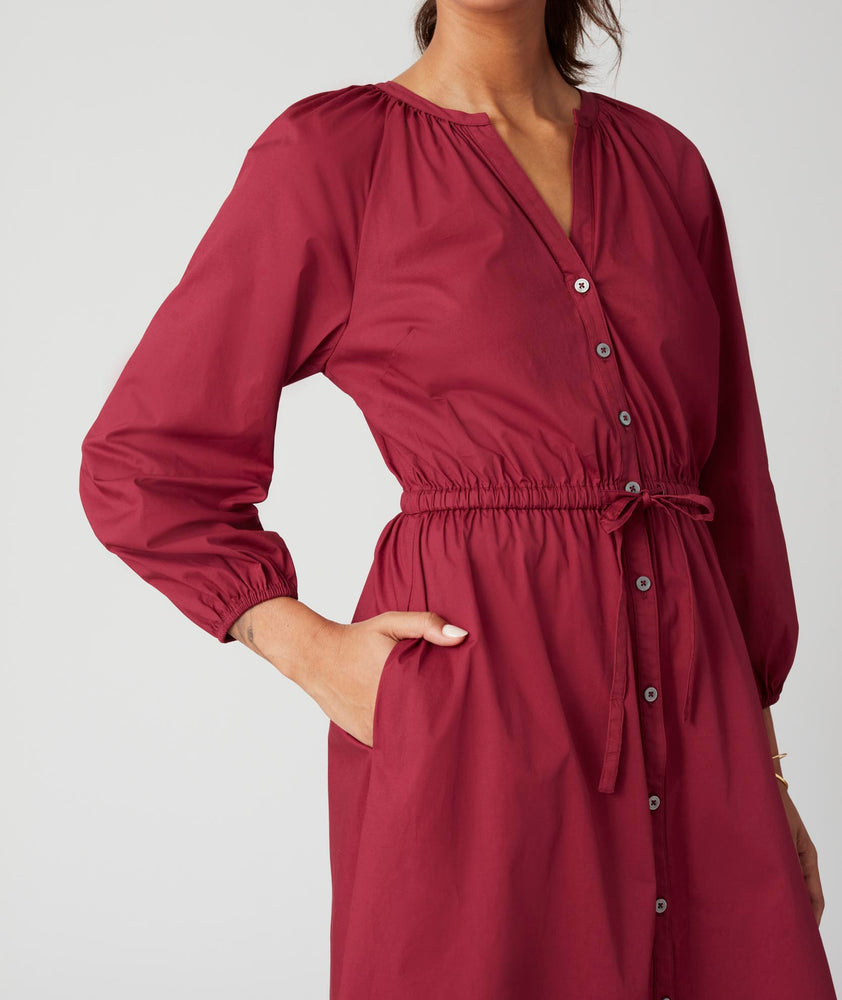 Model is wearing UNTUCKit Farrah dress in red.