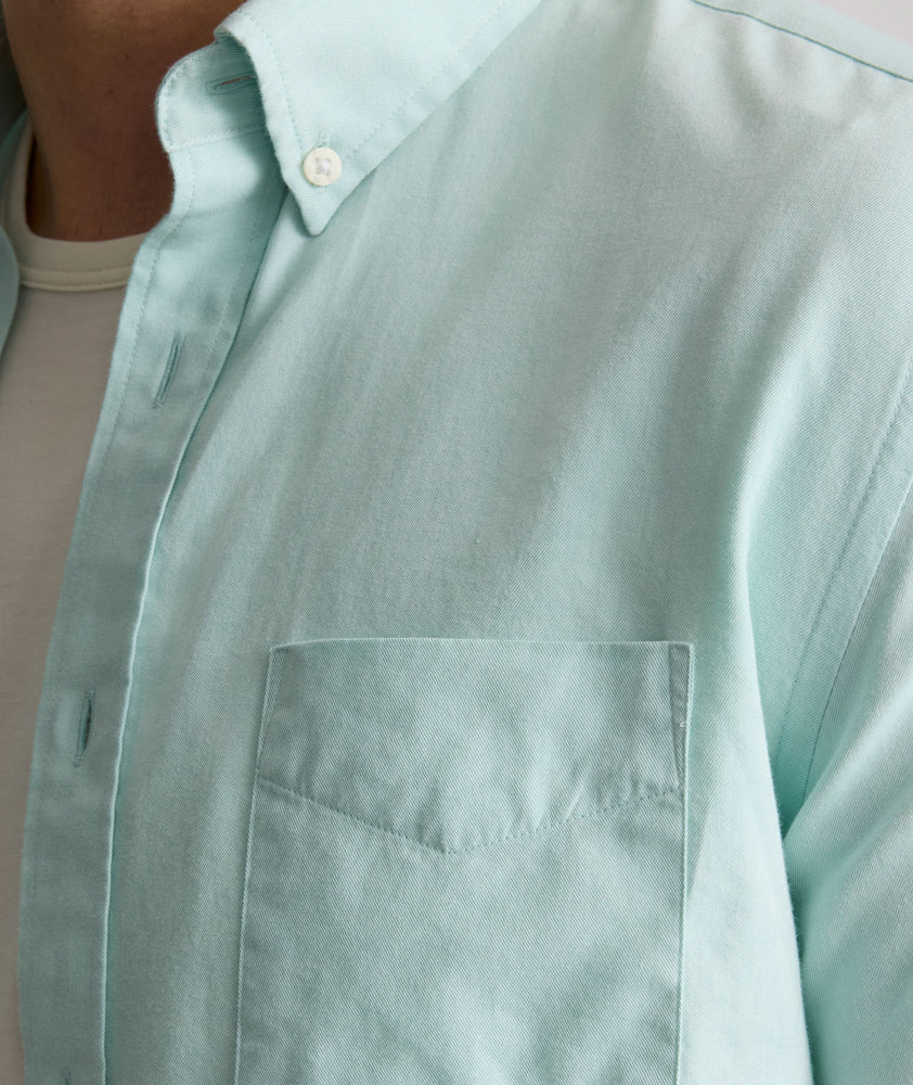 Model is wearing UNTUCKit Farnsworth in vintage wash solid marine blue. 