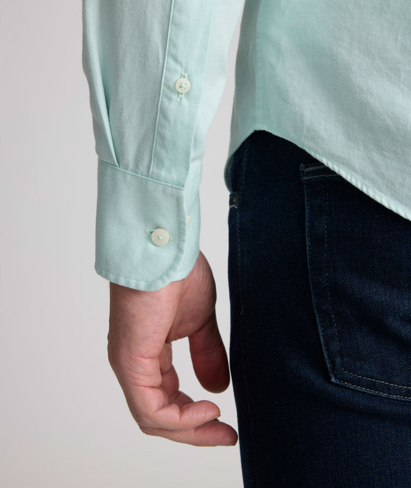 Model is wearing UNTUCKit Farnsworth in vintage wash solid marine blue. 