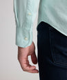 Model is wearing UNTUCKit Farnsworth in vintage wash solid marine blue. 