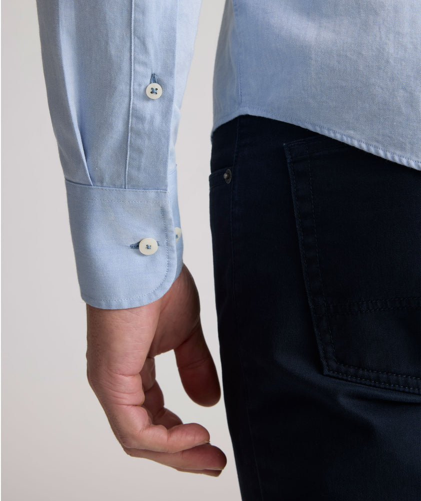 Model is wearing UNTUCKit Farnsworth in vintage wash solid ultramarine. 