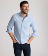 Model is wearing UNTUCKit Farnsworth in vintage wash solid ultramarine. 