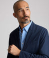 Model is wearing UNTUCKit Performance Blazer in navy. 