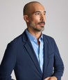 Model is wearing UNTUCKit Performance Blazer in navy. 
