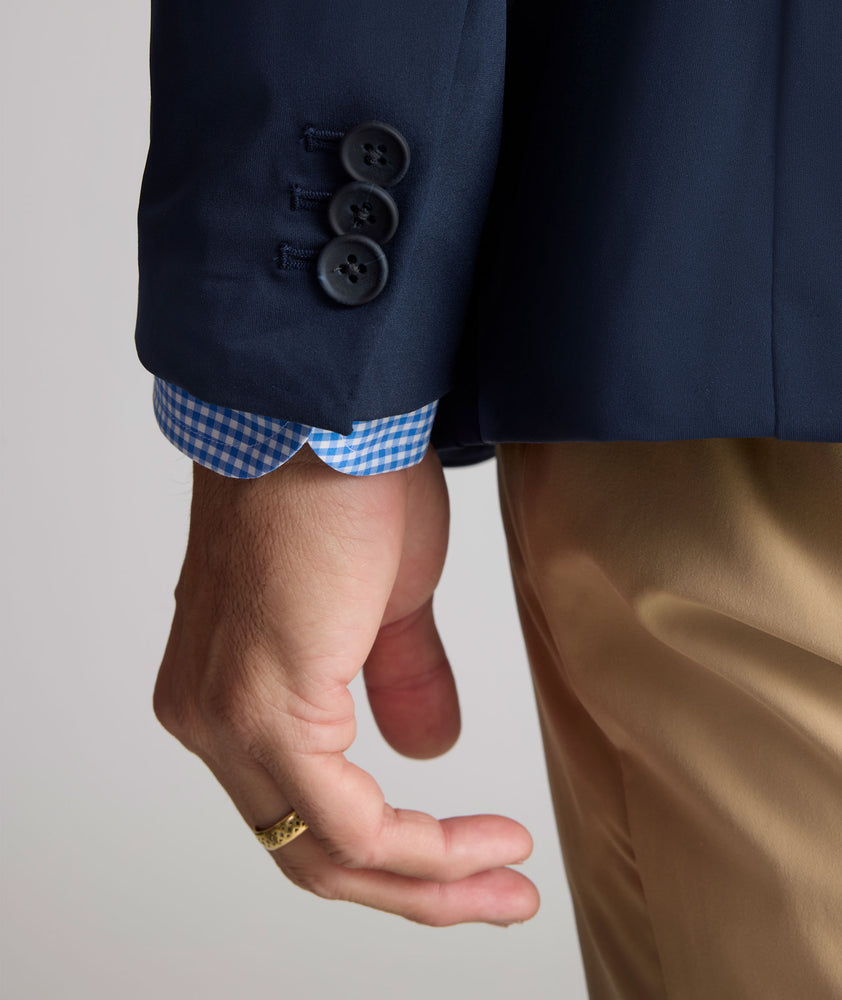 Model is wearing UNTUCKit Performance Blazer in navy. 