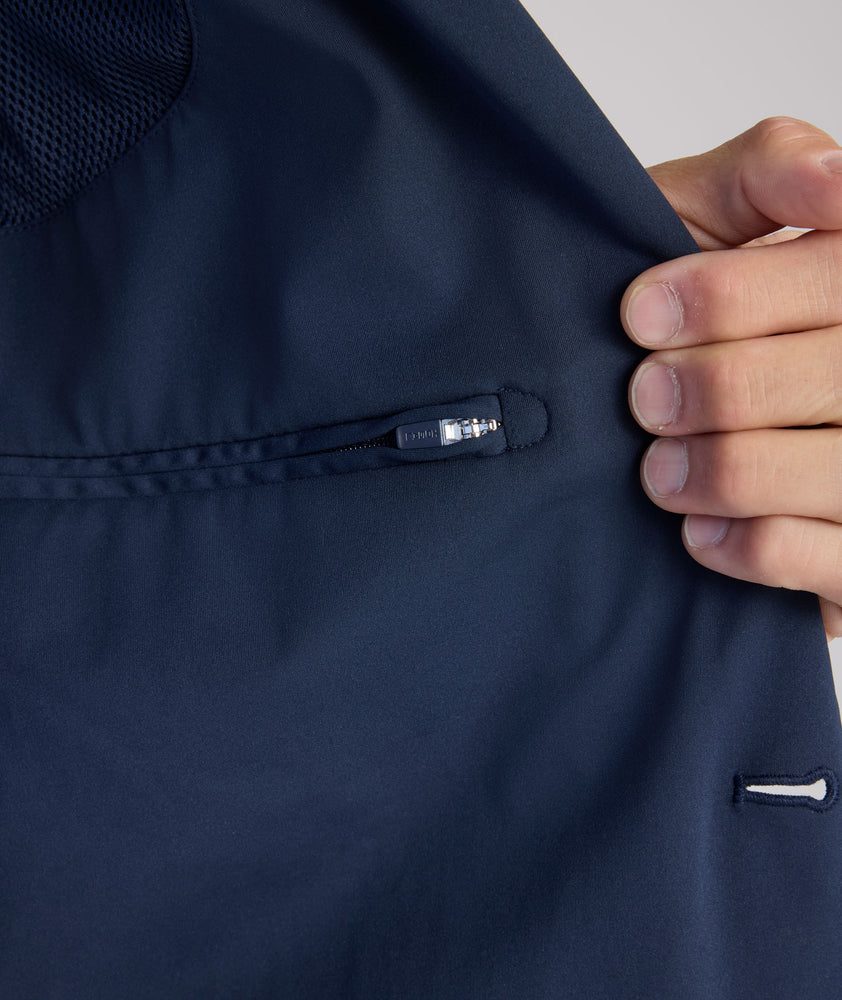 Model is wearing UNTUCKit Performance Blazer in navy. 