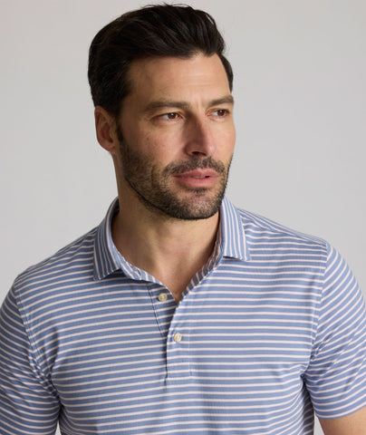 Model is wearing UNTUCKit Fernandez polo in stonewash.
