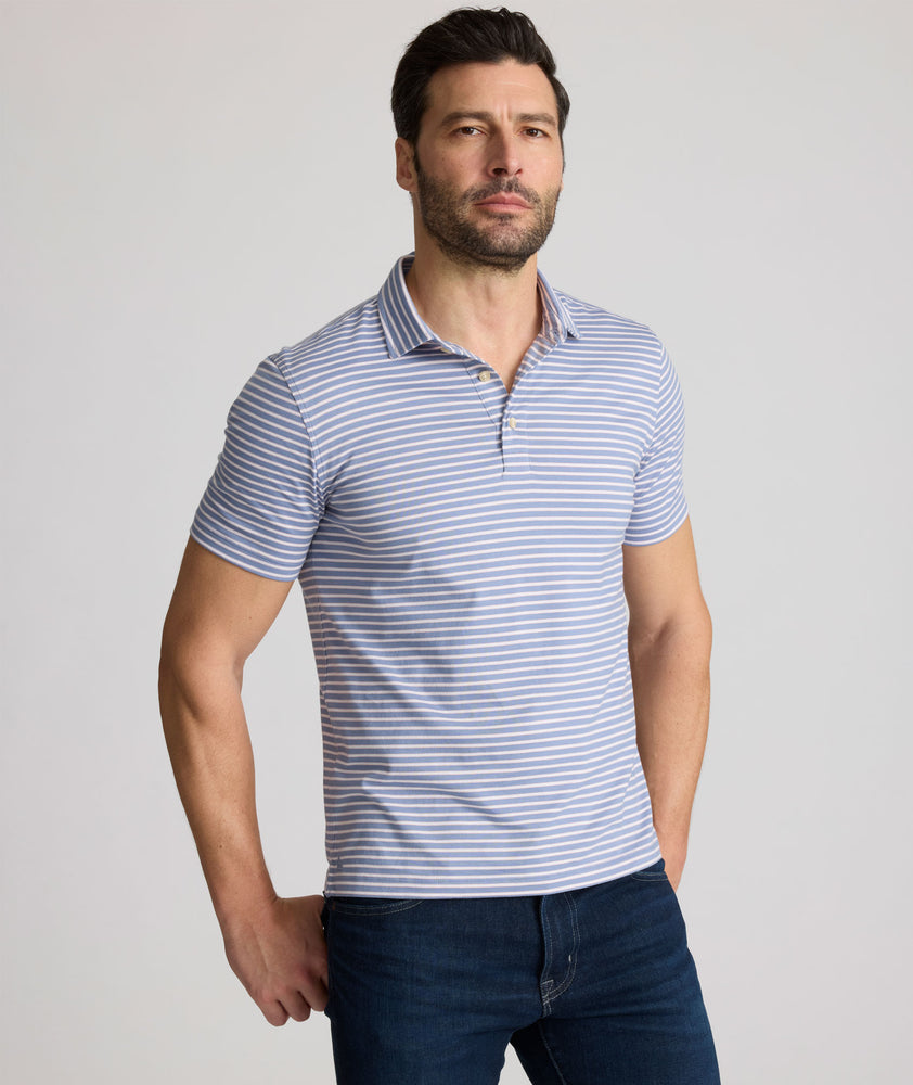 Model is wearing UNTUCKit Fernandez polo in stonewash.