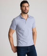 Model is wearing UNTUCKit Fernandez polo in stonewash.