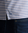 Model is wearing UNTUCKit Fernandez polo in stonewash.