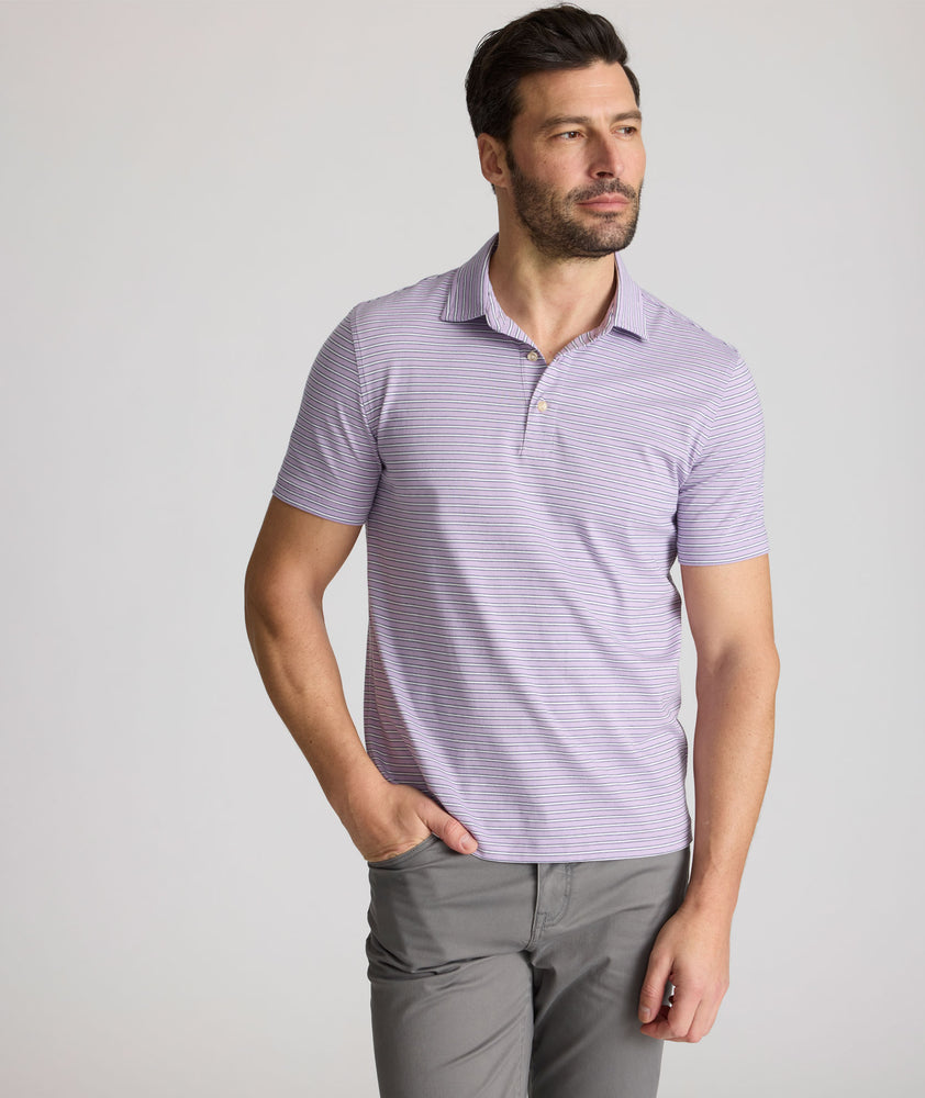Model is wearing UNTUCKit Fernandez polo in lavender. 
