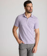 Model is wearing UNTUCKit Fernandez polo in lavender. 