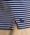 Model is wearing UNTUCKit Fernandez Striped Performance Polo in Blue Print.