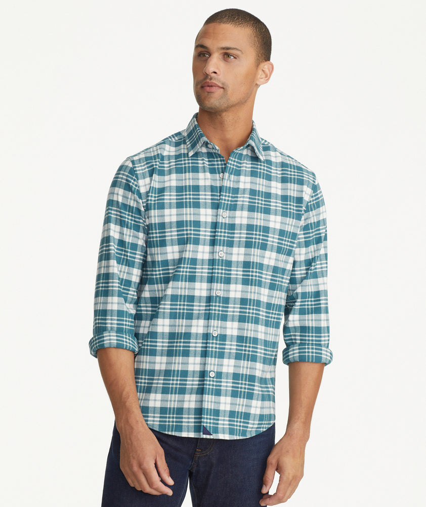 Model is wearing UNTUCKit Wrinkle-Free Performance Flannel Ferney Shirt in teal plaid.