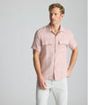 Model is wearing UNTUCKit Wrinkle-Resistant Linen Short-Sleeve Finnegan Shirt in tan. 