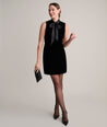 Model is wearing UNTUCKIt fiona velvet black dress. 