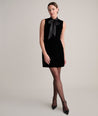 Model is wearing UNTUCKIt fiona velvet black dress. 