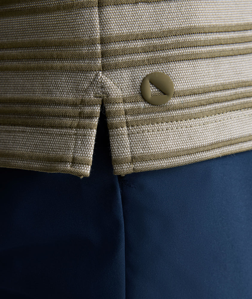 Model is wearing UNTUCKit Performance Hybrid Polo in dark green. 