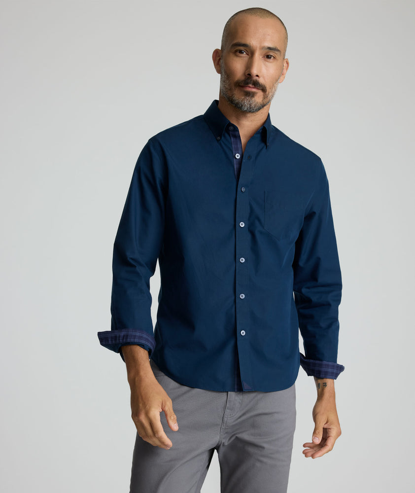Model is wearing UNTUCKit Fonteplant shirt in navy. 