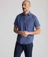 Model is wearing UNTUCKIt Performance Seersucker Short-Sleeve Shirt in dark blue. 